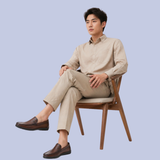 A model showing the chestnut brown Men's Full-Grain Leather Dress Slip-On Loafers