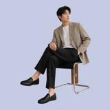 A model showing the deep onyx black Details of the Men's Full-Grain Leather Dress Slip-On Loafers