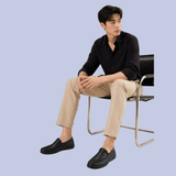 A model wearing the deep onyx black Details of the Men's Full-Grain Leather Dress Slip-On Loafers