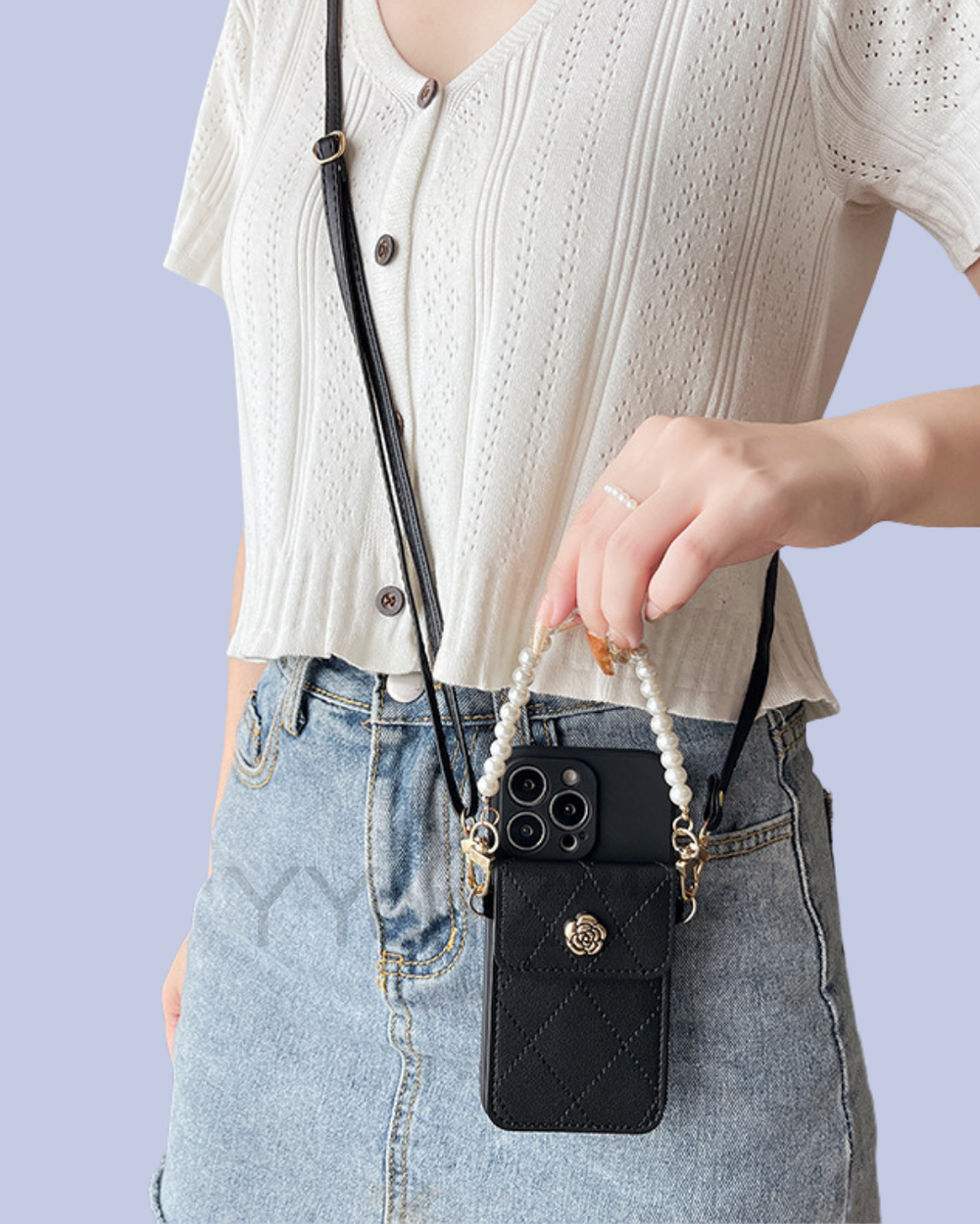 The black Crossbody Quilted iPhone Wallet Case with Pearl Chain Strap in real life
