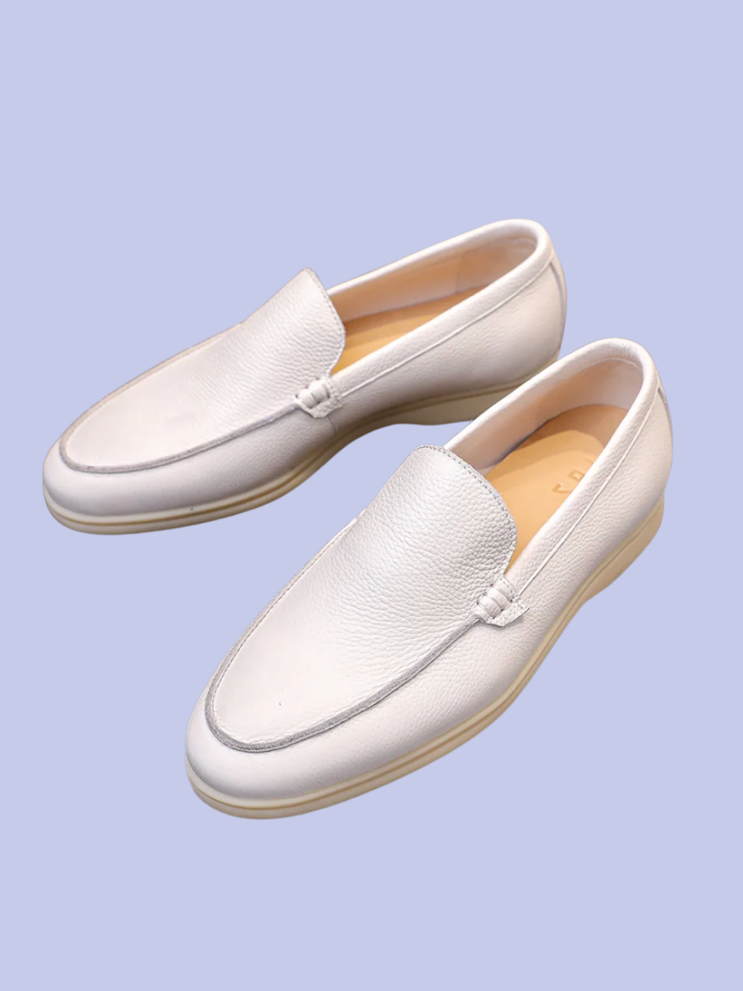 The display of the white Pebbled Leather Slip-On Loafers