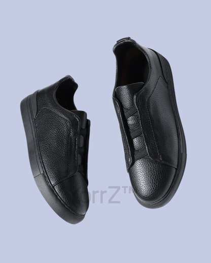 A slide view of the Black Triple Stitch Slip-On Low-Top Sneakers